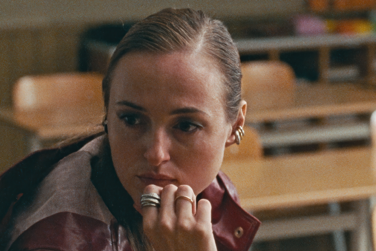 Renate Reinsve, protagonista del film Armand, seduta in un’aula scolastica, con uno sguardo profondo e riflessivo. Lo scatto cattura l’atmosfera tesa e introspeziva del film diretto da Halfdan Ullmann Tøndel, in uscita il 1° gennaio con Movies Inspired.